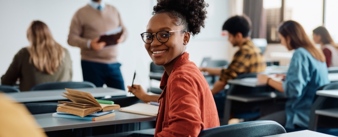 Smiling students in a classroom, article on EdTech Solutions